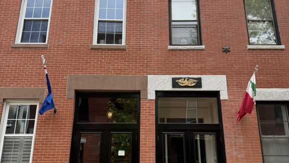 2 1/2 story brick double house with paired entries and stone foundation